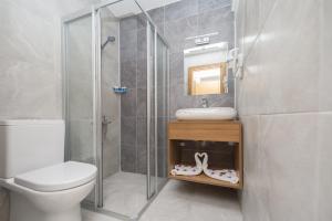 a bathroom with a shower and a sink and a toilet at Amore Hotel Teki̇rova in Tekirova