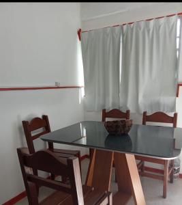 a dining room table with chairs and a bowl on it at Apartamento amueblado en Carmelo con aire acondicionado in Carmelo