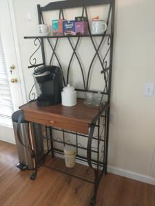 a black iron shelf with a coffee maker on it at Sweet Boutique Suite in Langley