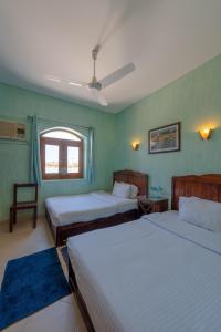 a bedroom with two beds and a window at El Gouna Rihana House sea view in Hurghada