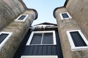 a tall building with three windows on the side of it at The Silos in Kewaunee