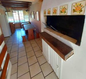 a kitchen with a counter and a table in a room at Pousada Los Casarones in Florianópolis