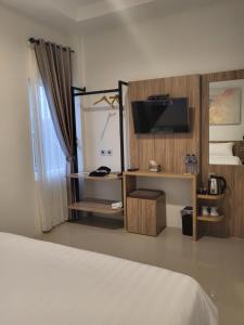 Voodi või voodid majutusasutuse The Safiina Point Syariah Hotel toas