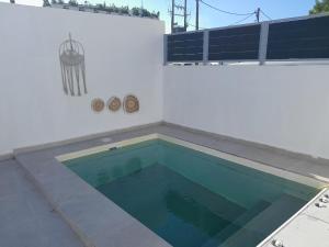 a swimming pool on the side of a house at SPILIOTICA VILLAS AND APARTMENTS in Imerovigli