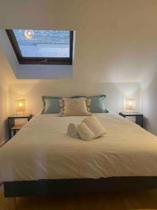 a bedroom with a large white bed with two lamps at LA PERLE DU THIOU - Charmant T3 au Centre d'Annecy avec Parking Privé in Annecy