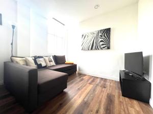 a living room with a couch and a television at Apartment - City Centre WV1 in Wolverhampton