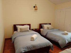 Habitación con 2 camas y toallas. en Bioelemental hotel sustentable Bogotá, en Bogotá