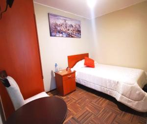 Habitación pequeña con cama y mesa. en Bon Repos Arequipa, en Arequipa