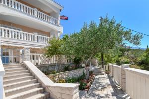 a house with stairs and a fence at Apartments by the sea Pisak, Omis - 10323 in Pisak