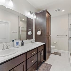 a bathroom with a sink and a large mirror at Newly Built Murphys Modern Retreat in Murphys