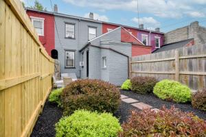 a backyard with a fence and some houses at Cozy Retreat in Downtown Lancaster with Backyard Patio in Lancaster