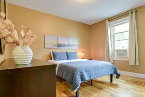 a bedroom with a bed and a vase of flowers at Cozy Retreat in Downtown Lancaster with Backyard Patio in Lancaster