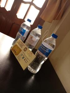 two bottles of water sitting on top of a table at Hostal Turismo Cruz de Piedra EIRL-Cajamarca in Cajamarca