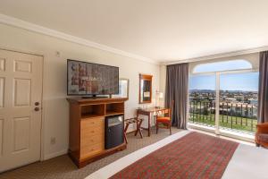 a hotel room with a bed and a large window at Camino Real Puebla Angelopolis in Puebla