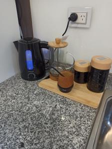 a kitchen counter with a blender and a cutting board at Departamento Elena 2 in Santa Rosa