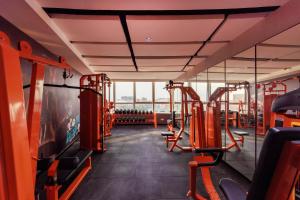 a gym with rows of treadmills and machines at Feili International Hotel in Guangzhou