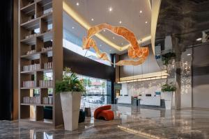 a lobby with a large orange snake hanging from the ceiling at Feili International Hotel in Guangzhou