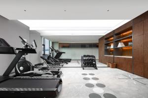 a row of treadmills and exercise equipment in a gym at UrCove by Hyatt Hangzhou Xiaoshan International Airport in Hangzhou