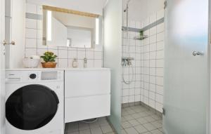 a laundry room with a washer and dryer at Stunning Apartment In Gudhjem With Wifi in Gudhjem