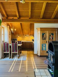 a living room with a wooden ceiling and a kitchen at Haus Oberland in Bad Endorf