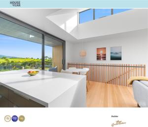 a kitchen and dining room with a white counter top at Coastal Living in Comfort in Raglan +10 photos