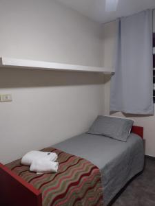 1 dormitorio con 1 cama con 2 toallas en IRUPE/Casa completa /pileta/cercana al rio en Granadero Baigorria