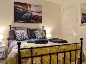 a bed with pillows on it in a bedroom at The Byre in Ingleby