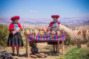 two women standing in front of a table with a camel at Sky Dome Peru in Cusco