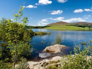 a view of a lake with mountains in the background at Sunnyside in New Galloway