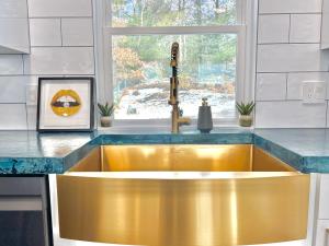 a kitchen with a gold sink in front of a window at Luxury 4 bedroom 2 bath Lake Views in Marlborough