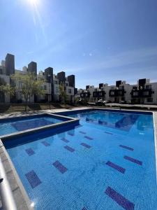 a large blue swimming pool on top of a building at Casa completa en condominio privado con alberca in Miranda