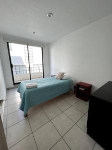 a bedroom with a bed and a large window at Casa completa en condominio privado con alberca in Miranda