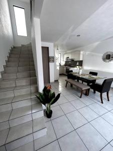 a living room with a table and a dining room at Casa completa en condominio privado con alberca in Miranda