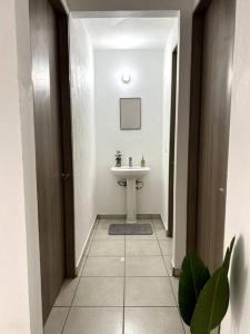 a bathroom with a sink and a toilet in it at Casa completa en condominio privado con alberca in Miranda