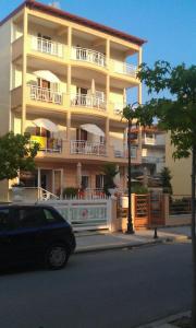 a building with balconies and a car parked in front of it at Marie Claire Studios in Olympic Beach