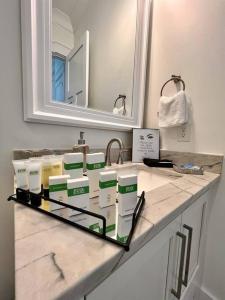 a bathroom counter withbranded products on top of it at Osprey -Luxury 3BDR Beach House in Orange Beach