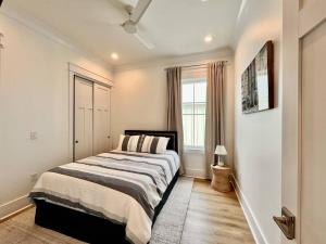 a bedroom with a bed and a window at Osprey -Luxury 3BDR Beach House in Orange Beach