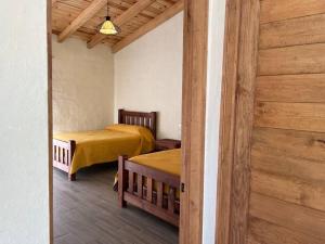Ένα ή περισσότερα κρεβάτια σε δωμάτιο στο Cabaña Venado Tapalpa