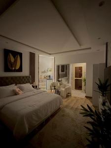 a bedroom with a large bed and a living room at Riyadh in Riyadh