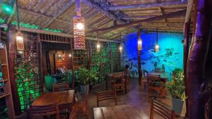 ein Restaurant mit Holztischen und -stühlen und einer blauen Wand in der Unterkunft Canoe Beach House & Spa in Tangalle