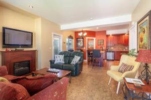 a living room with couches and a fire place at Orchard & Vines Villa Penticton in Penticton