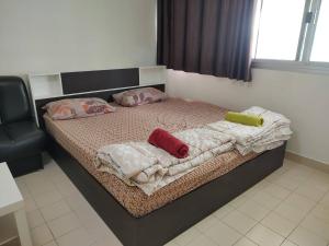 a bedroom with a bed with two pillows on it at ป็อปปูล่าคอนโด เมืองทองใกล้อิมแพค สะดวกสบาย in Ban Bang Phang
