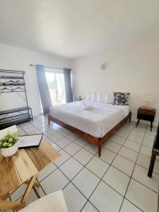 拉哈斯的住宿－Nautilus by La Jamaca Hotels-Downtown La Parguera，一间卧室配有一张大床和一张桌子