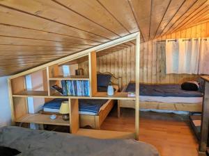 a bedroom with two bunk beds and a desk at Appartement La Clusaz, 2 pièces, 6 personnes - FR-1-459-214 in La Clusaz