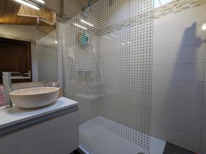 a bathroom with a sink and a glass shower at Appartement La Clusaz, 2 pièces, 6 personnes - FR-1-459-214 in La Clusaz