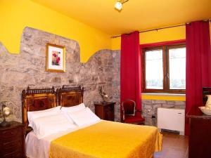 a bedroom with a bed with yellow and red curtains at Property in Trivigno PZ in Trivigno