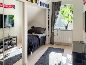 a bedroom with a bed and a window at Holiday home RÅÅ in Råå 