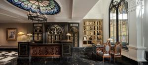 a room with a desk and a stained glass window at Le Chanvre Hanoi Hotel & Spa in Hanoi