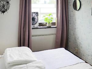 a bed in a room with a window and a window at 4 star holiday home in ULLARED-By Traum in Ullared +28 photos