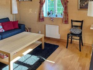 - un salon avec un canapé, une table et une chaise dans l'établissement Holiday home SÖLVESBORG XII, à Sölvesborg